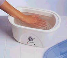 wax bath image with hand in wax